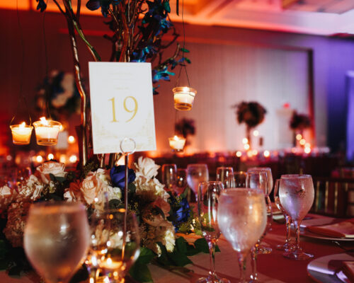 Wine glasses on the served table with lightening candles and tab